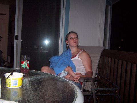 1994 Ford Probe - A woman sits on a porch with a baby, looking away from the camera.
