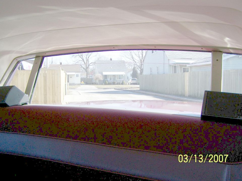Interior view of rear window and red parcel shelf of a car