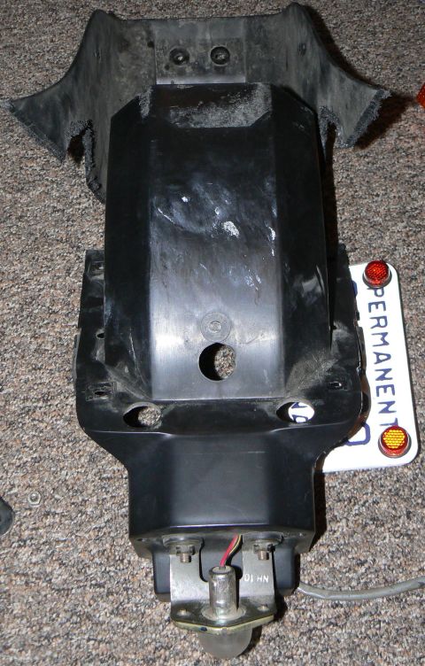 2002 Kawasaki Ninja - Disassembled motorcycle tail section with license plate, likely for repair or modification.
