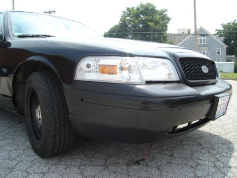 2000 Ford Crown Victoria - Front view of a black 2000 Ford Crown Victoria, showing its distinctive grille and headlights.
