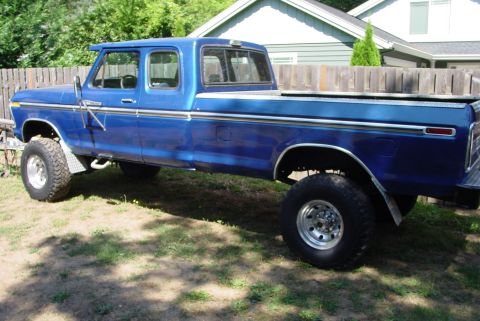 1993 Ford Bronco - This blue crew cab pickup truck is modified with a lifted suspension and oversized tires.