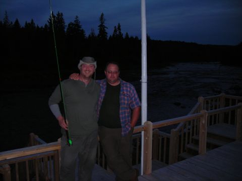 1984 Ford Bronco - Two men pose on a wooden deck at dusk, with a body of water and trees in the background.