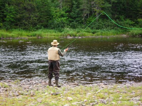 1984 Ford Bronco - A person enjoys a peaceful day of fly fishing by the river.