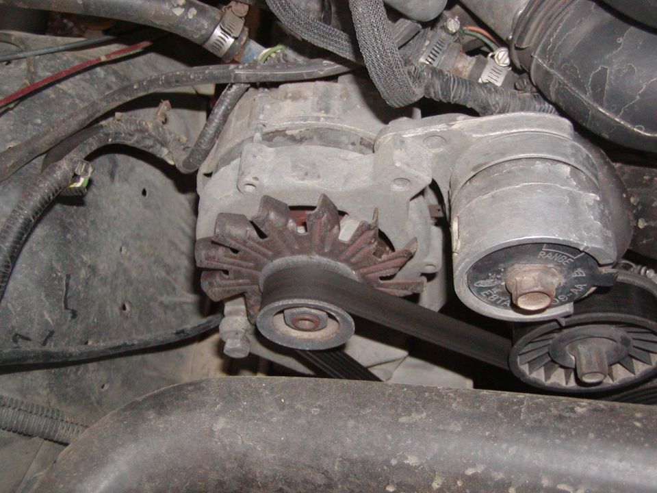 Ford alternator with part number E8TF-10300-AA visible, connected to a serpentine belt