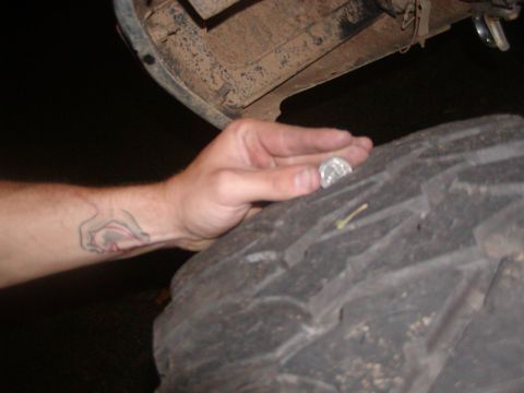 1991 Ford Bronco - Checking tire tread depth with a coin.