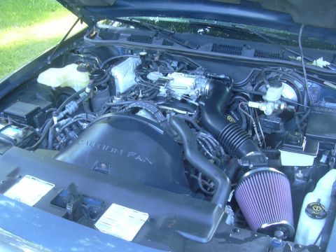 1996 Ford Crown Victoria - Engine bay of a 1996 Ford Crown Victoria shows the V8 engine and aftermarket air intake system.