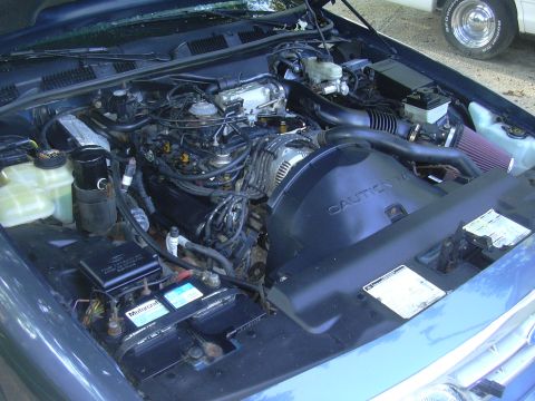 1996 Ford Crown Victoria - Engine bay of a 1996 Ford Crown Victoria, showing the engine and air intake system.