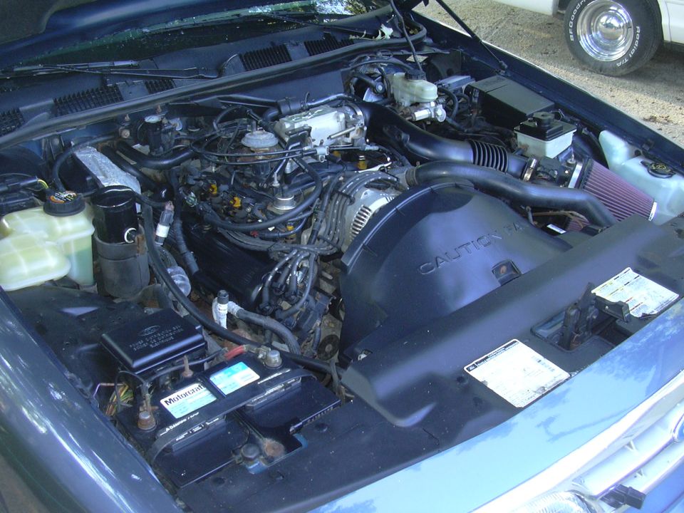 1996 Ford Crown Victoria engine bay with aftermarket cone filter and blue paint