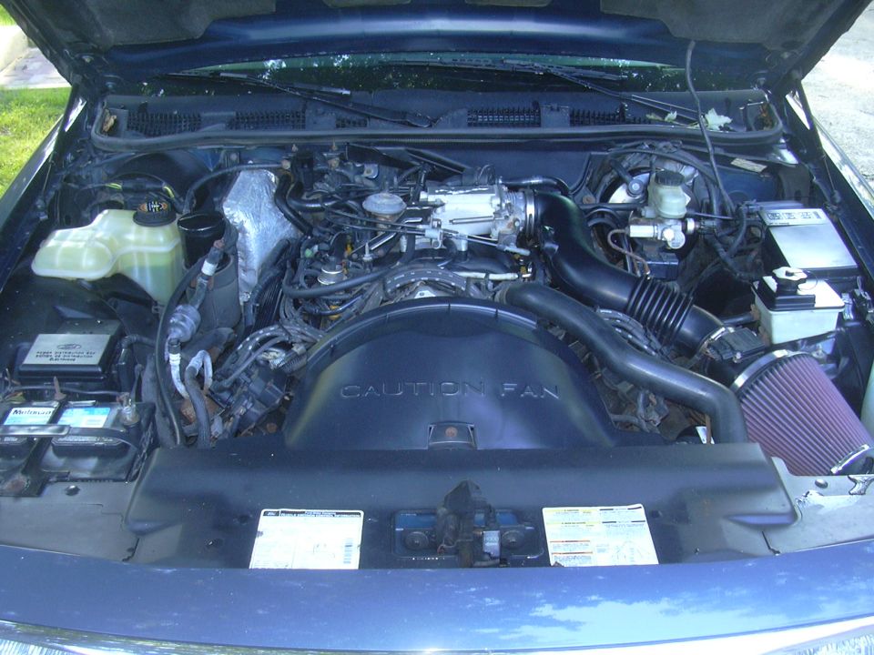 1996 Ford Crown Victoria engine bay with a cone filter and "CAUTION FAN" shroud