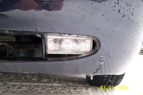 2003 Ford Crown Victoria - Close-up of the front bumper fog light on a 2003 Ford Crown Victoria, showing ice formations.