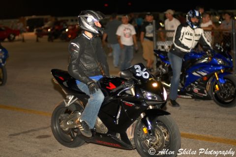 2006 Honda CBR-RR - A rider sits on a black 2006 Honda CBR-RR motorcycle with the number 36 displayed on the front fairing, at a drag strip event.