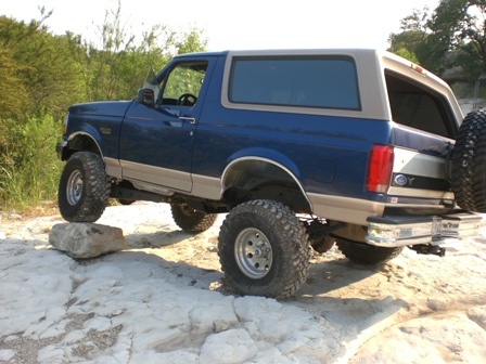 1996 Ford Bronco - This lifted 1996 Ford Bronco navigates rocky terrain, its off-road capabilities.