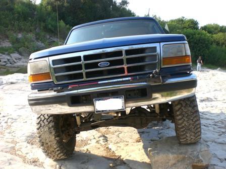 1996 Ford Bronco - Blue 1996 Ford Bronco front view on rocky terrain.