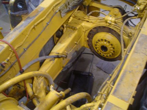 1966 International School Bus - Underside view of yellow heavy machinery, showing the transmission and drive components.