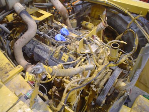 1966 International School Bus - A close-up view of a complex engine compartment, showing numerous hoses, pipes, and mechanical parts.