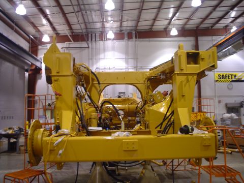 1966 International School Bus - Heavy machinery engine assembly undergoing maintenance or construction in a workshop environment.