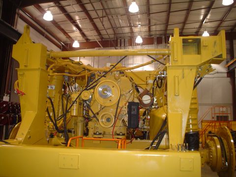 1966 International School Bus - A large yellow industrial engine is shown in a workshop setting, with complex piping and mechanical components visible.