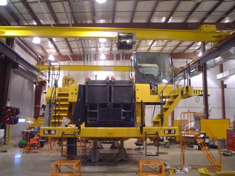 1966 International School Bus - Industrial vehicle undergoing maintenance or construction in a workshop setting.