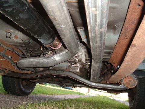 1990 Ford Ranger - Underside view of a vehicle's exhaust system, driveshaft, and transmission components.