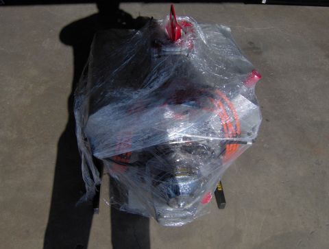 1978 Ford Bronco - Engine wrapped in plastic wrap, with red accents visible.