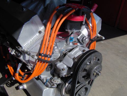 1978 Ford Bronco - Close-up view of a V8 engine, prominent orange spark plug wires and a serpentine belt system.