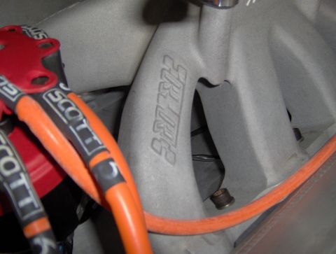 1978 Ford Bronco - Close-up of an engine intake manifold with visible branding and wiring.