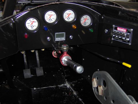 1978 Ford Bronco - Interior view of a custom racing vehicle's dashboard with multiple gauges and switches.