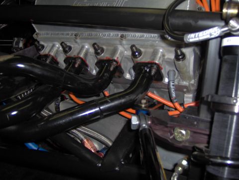 1978 Ford Bronco - Detailed view of an engine's internal components, including spark plug wires and exhaust headers.