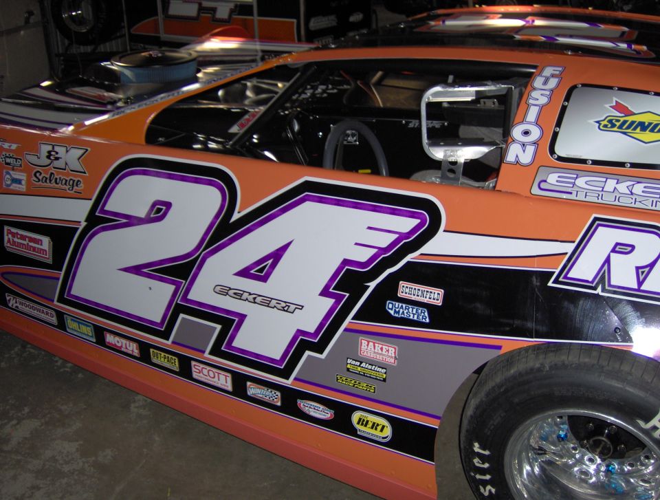 Race car with number 24 and "ECKERT" on the side, orange and black paint scheme