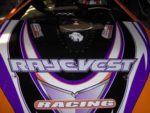 1978 Ford Bronco - The hood of a race car displays prominent 'RAYE VEST RACING' lettering and sponsor decals.