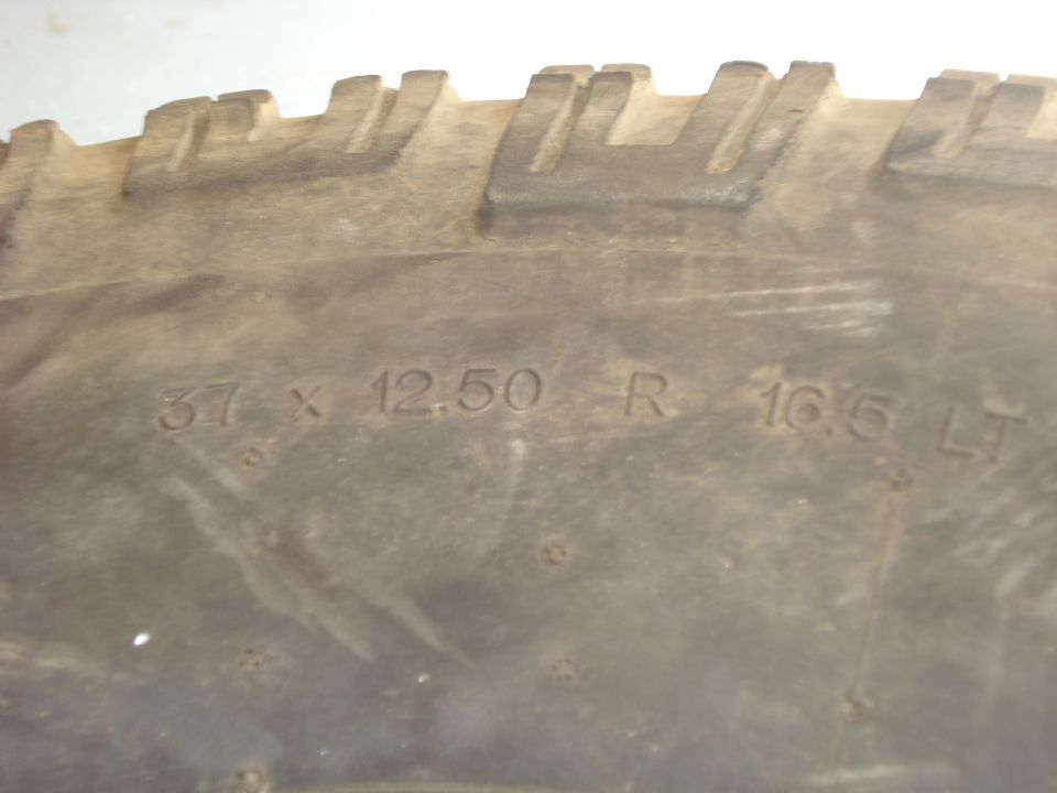 Close-up of an off-road tire sidewall reading 37 x 12.50 R 16.5 LT