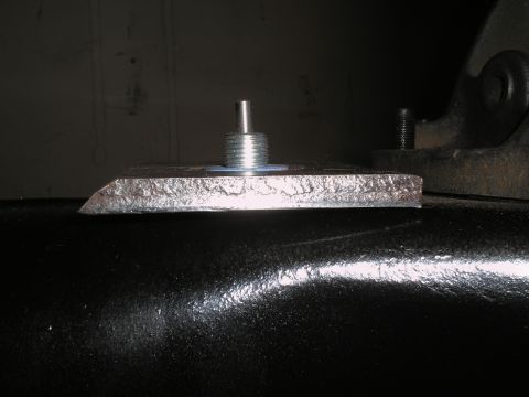 1990 Ford Bronco - Close-up of a metal bracket and bolt assembly, likely a vehicle part.