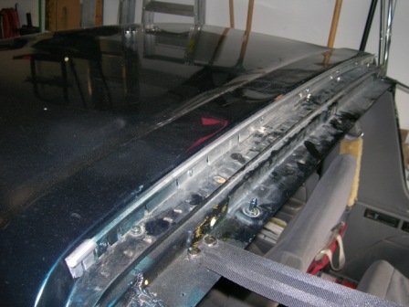 1995 Ford Bronco - Detail of a vehicle's interior roof seam, with visible hardware and wear.