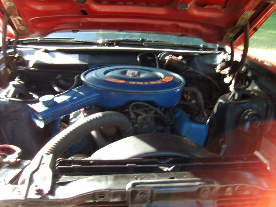1970 Ford Ranchero engine bay with blue air cleaner and red hood