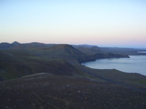1996 Ford Bronco - A wide shot of a tranquil bay surrounded by rolling hills under a fading sky.