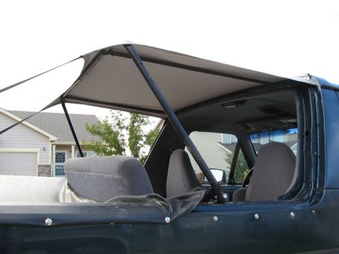 1995 Ford Bronco - Interior view of a 1995 Ford Bronco, highlighting the soft top frame and seats.