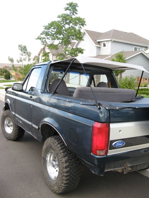 1995 Ford Bronco - This 1995 Ford Bronco features a removable soft top, exposing the interior and rear seating area.