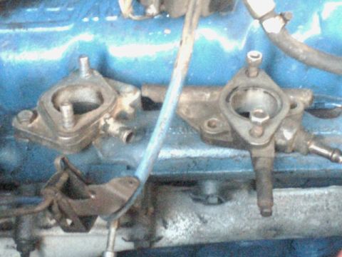 1968 Ford Mustang - Close-up view of engine intake manifold components, likely from a classic car.