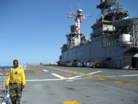 1986 Ford Bronco - A sailor walks on the flight deck of the USS Wasp, with other vehicles visible on the deck.