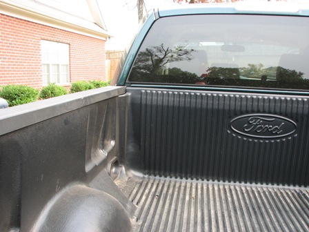 1991 Ford Bronco - Close-up of the Ford emblem on the tailgate of a Ford truck.