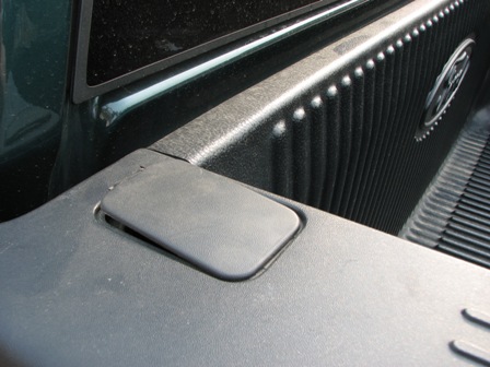 1991 Ford Bronco - The textured interior of a truck bed shows a prominent Ford emblem on the side wall.