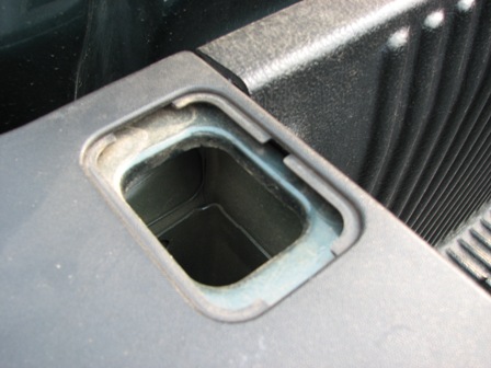 1991 Ford Bronco - Close-up of a truck bed anchor point, showing its construction and texture.