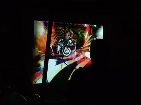 1991 Ford Probe - A person watches a colorful projection of a drummer performing on a drum kit.