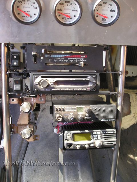 1990 Ford Bronco - fabricated dash panel with Auto Meter gauges, a Sony stereo, a Cobra CB radio and a two-way radio in a race vehicle.