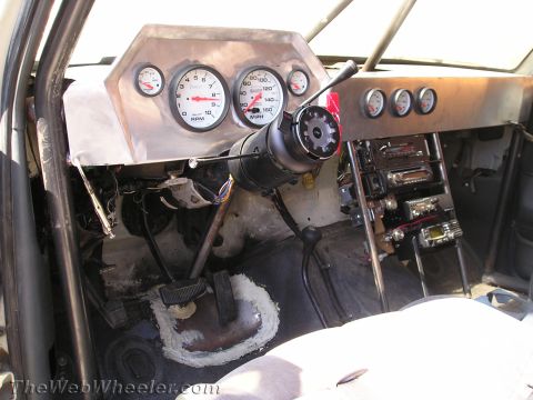 1990 Ford Bronco - Bare race-truck cab with an aluminum dash, Auto Meter gauges, exposed steering column and floor shifter.