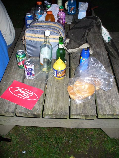 1991 Ford Probe - A picnic table is laden with various drinks, snacks, and a Ford logo sticker.