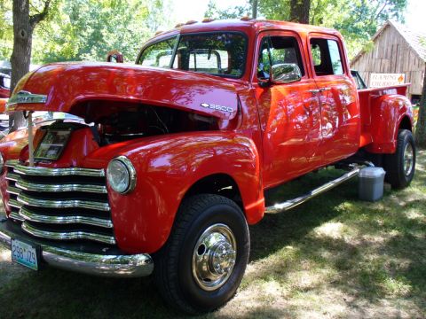 1995 Ford Thunderbird - This classic red Chevrolet 3500 pickup truck, a four-door cab and dual rear wheels, is displayed with its hood open.