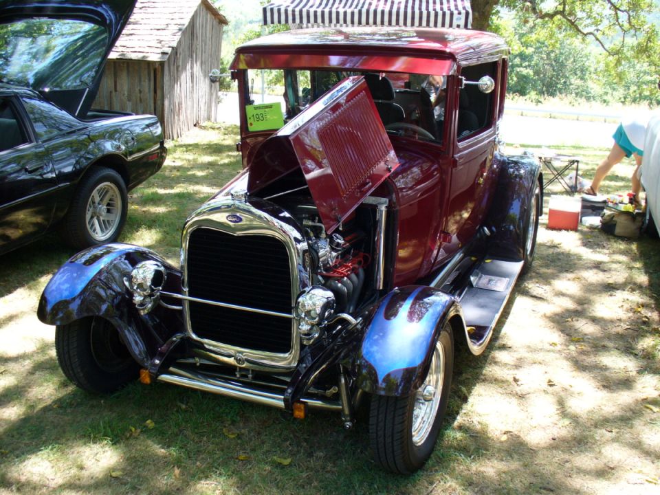 1931 Ford hot rod, front view, maroon with blue flame fenders and skull accents