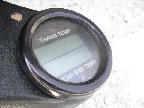 1993 Ford C-350 (Centurion Conversions) - Close-up of a digital gauge displaying transmission and rear end temperatures, with 'DESIGN' visible.