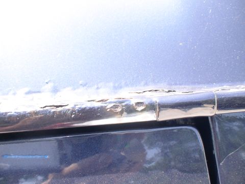 1993 Ford C-350 (Centurion Conversions) - The vehicle's trim shows extensive rust damage, indicating a need for repair.